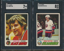 Load image into Gallery viewer, Two hockey trading cards featuring Bobby Orr and Bryan Trottier in protective cases.